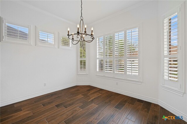 815 Lost Maples Trl, Georgetown, TX 78633 - unfurnished dining area with a chandelier, dark wood-style flooring, crown molding, and baseboards