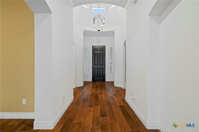 815 Lost Maples Trl, Georgetown, TX 78633 - hall featuring wood finished floors, baseboards, arched walkways, and a chandelier