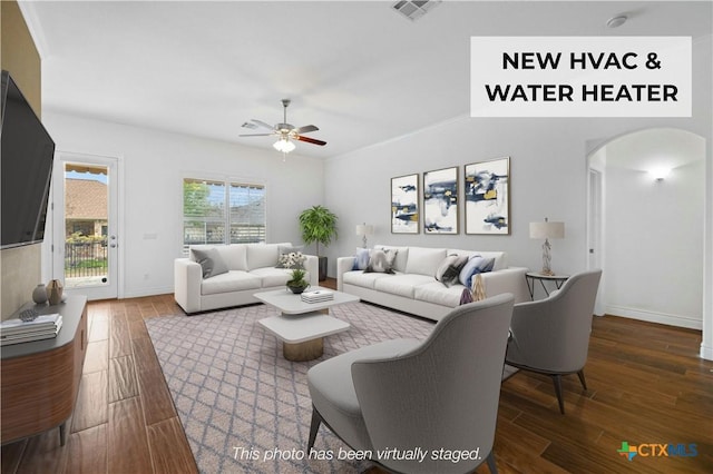 815 Lost Maples Trl, Georgetown, TX 78633 - living room featuring ceiling fan, wood finished floors, arched walkways, and baseboards