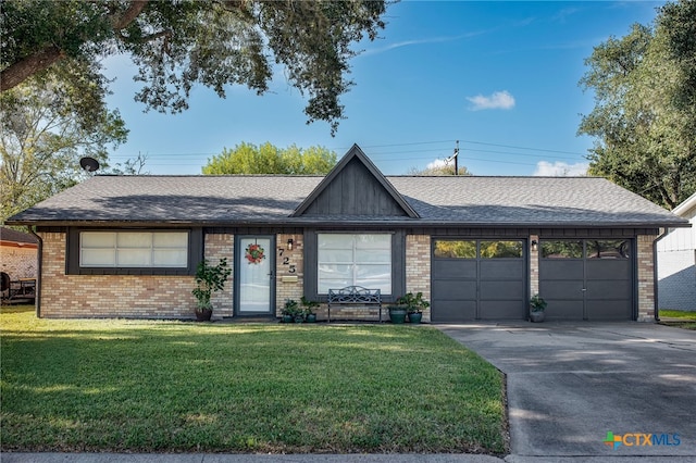 ranch-style home with a garage and a front lawn