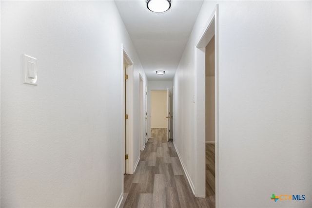 hallway with light hardwood / wood-style flooring