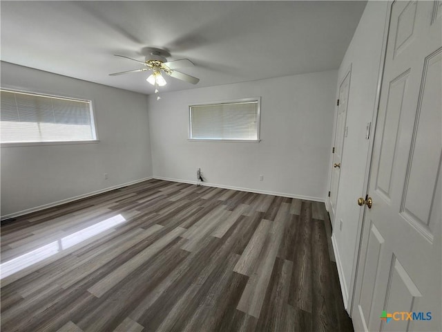 spare room with dark hardwood / wood-style floors and ceiling fan