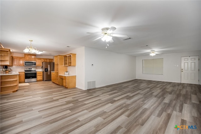 unfurnished living room featuring light hardwood / wood-style floors and a notable chandelier