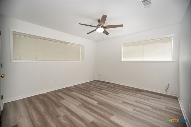 spare room featuring ceiling fan and light hardwood / wood-style floors