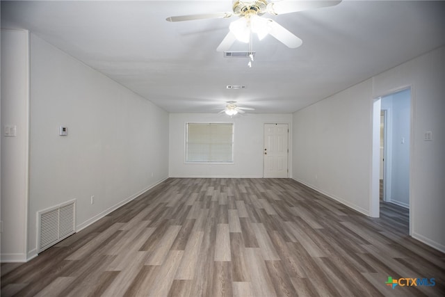 spare room with ceiling fan and hardwood / wood-style flooring