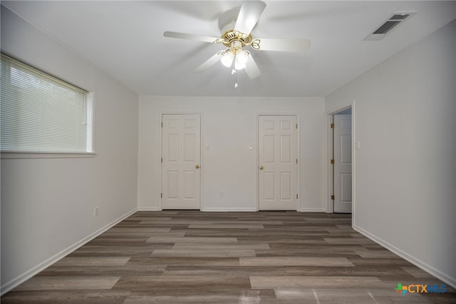 interior space with ceiling fan and dark wood-type flooring