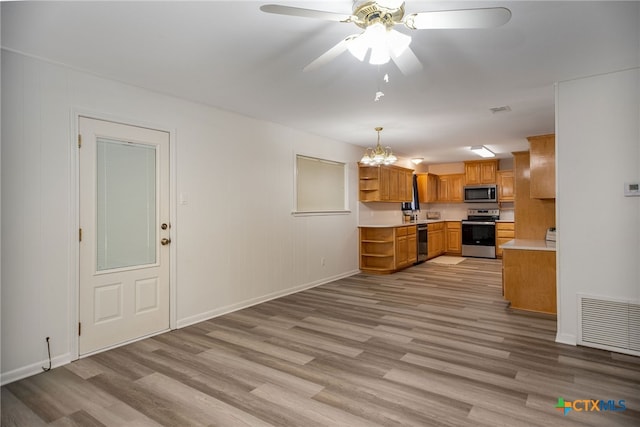 kitchen featuring decorative light fixtures, light wood-type flooring, ceiling fan with notable chandelier, and appliances with stainless steel finishes