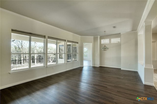 empty room with dark wood finished floors, plenty of natural light, and crown molding