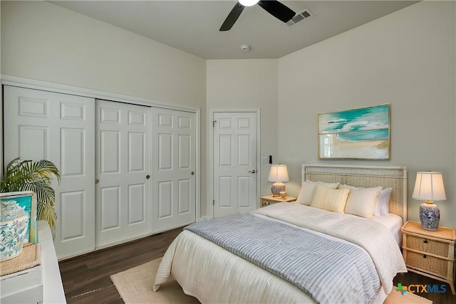 bedroom with wood finished floors, visible vents, a closet, and ceiling fan