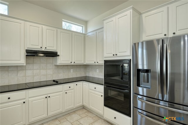 kitchen featuring decorative backsplash, black appliances, dark countertops, and under cabinet range hood