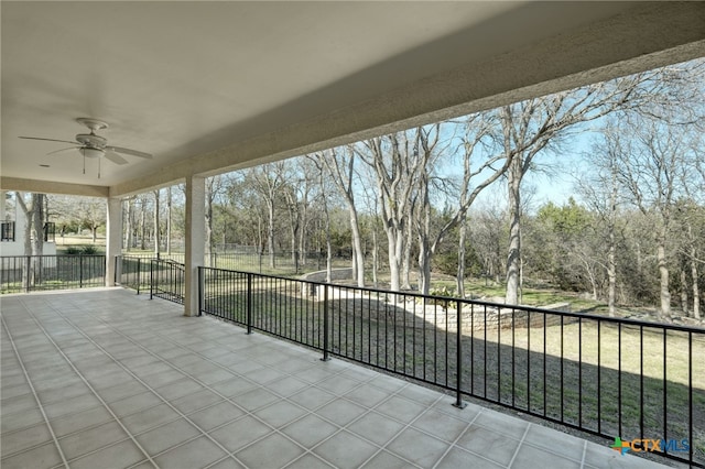 unfurnished sunroom featuring ceiling fan