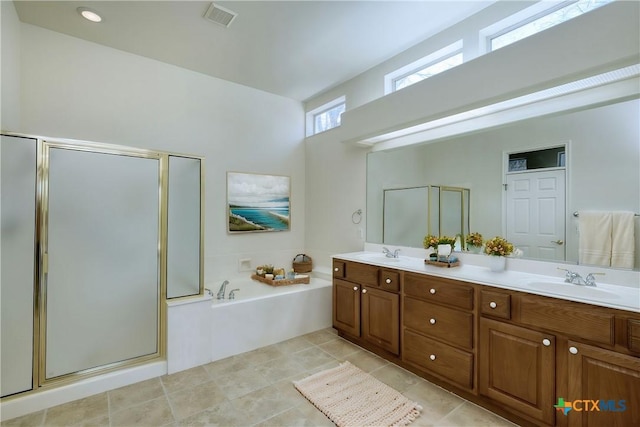 bathroom with a shower stall, a bath, double vanity, and a sink