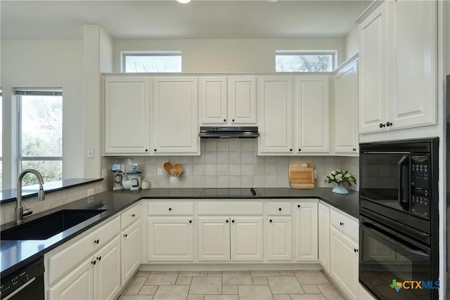 kitchen featuring black appliances, under cabinet range hood, decorative backsplash, white cabinetry, and a sink