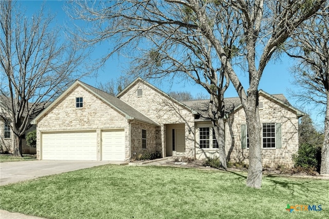 single story home featuring stone siding, a front yard, an attached garage, and driveway