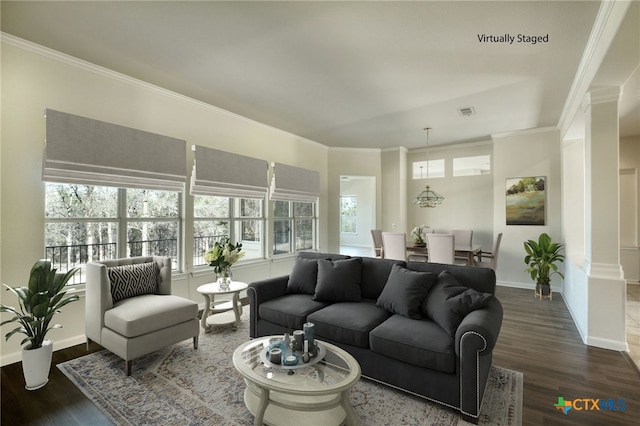 living area featuring crown molding, baseboards, and wood finished floors