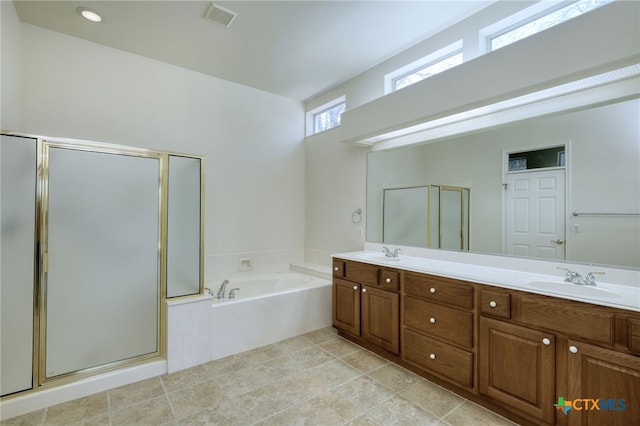 full bath with double vanity, a stall shower, a garden tub, and a sink