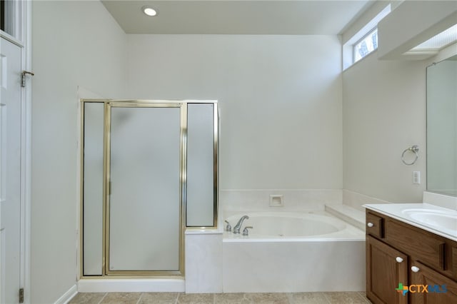 bathroom featuring a stall shower, vanity, and a bath