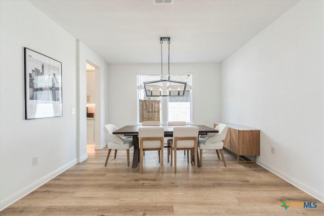 288 Smithsonian Ln, Kyle, TX 78640 - dining space featuring visible vents, baseboards, light wood-style floors, and a chandelier