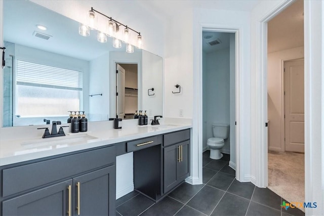 288 Smithsonian Ln, Kyle, TX 78640 - full bathroom with toilet, tile patterned flooring, a sink, and visible vents
