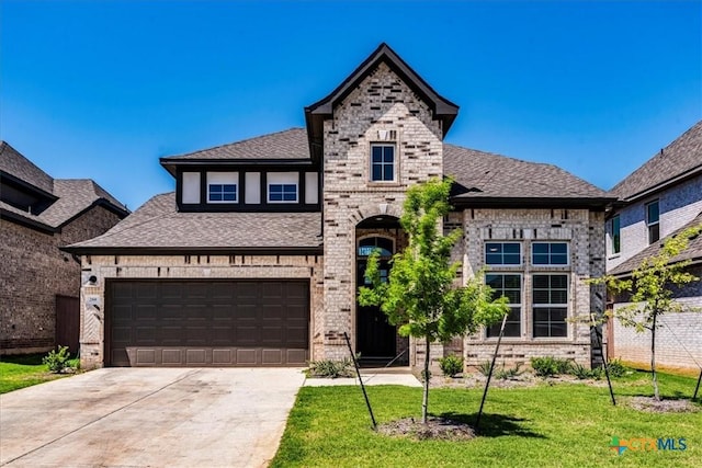 288 Smithsonian Ln, Kyle, TX 78640 - view of front of house with a front lawn, driveway, fence, brick siding, and a shingled roof