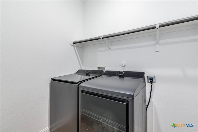 288 Smithsonian Ln, Kyle, TX 78640 - laundry room featuring baseboards, washer and clothes dryer, and laundry area
