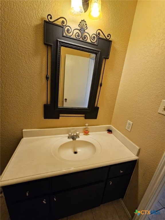 bathroom with tile patterned flooring and vanity