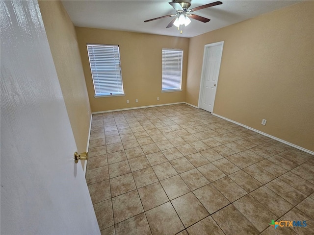 tiled empty room with ceiling fan