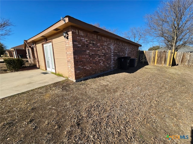 view of side of home with cooling unit and a patio area