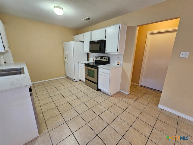 kitchen with tasteful backsplash, sink, white cabinets, stainless steel range with electric stovetop, and white refrigerator with ice dispenser