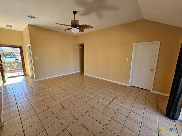 tiled empty room featuring ceiling fan and lofted ceiling