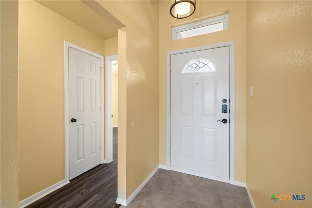 tiled entryway with baseboards