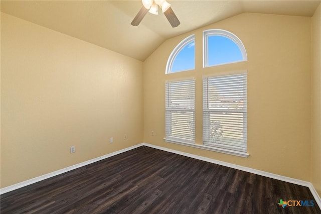 unfurnished room featuring a healthy amount of sunlight, dark wood-style floors, baseboards, and lofted ceiling