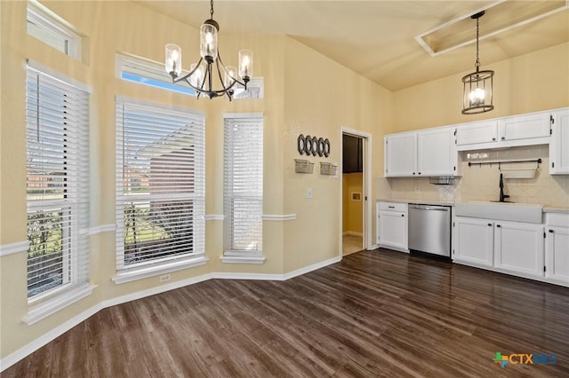 kitchen with stainless steel dishwasher, dark wood-style flooring, a sink, and white cabinets