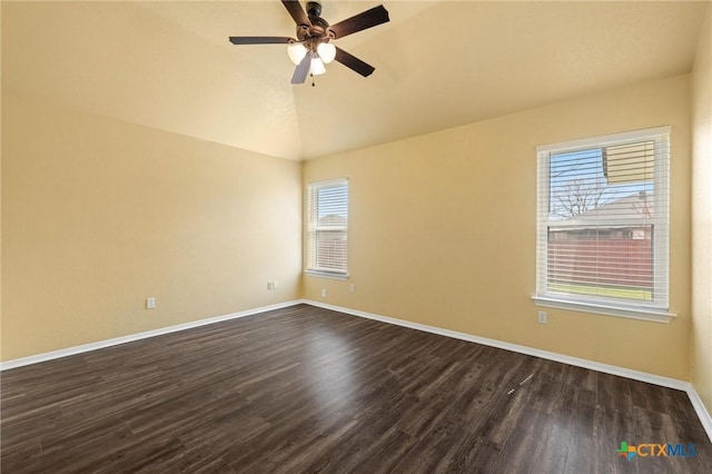 unfurnished room with lofted ceiling, ceiling fan, baseboards, and dark wood-style flooring