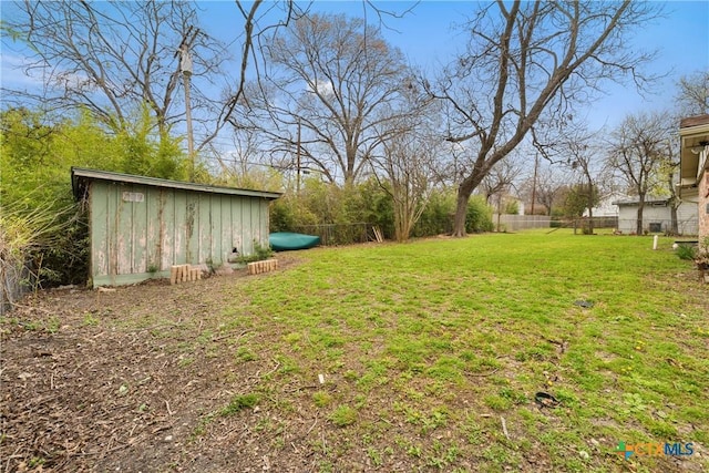 view of yard with an outdoor structure and fence