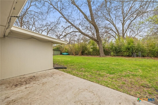 view of yard featuring fence and a patio area