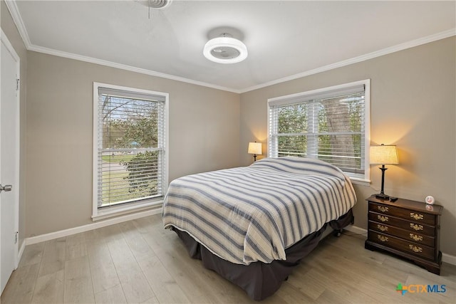 bedroom featuring baseboards, light wood finished floors, and ornamental molding