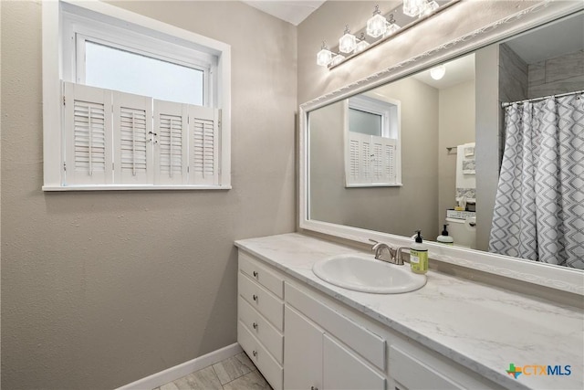 full bath with a shower with shower curtain, baseboards, toilet, and vanity