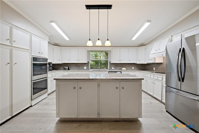 kitchen featuring lofted ceiling, tasteful backsplash, a kitchen island, and stainless steel appliances