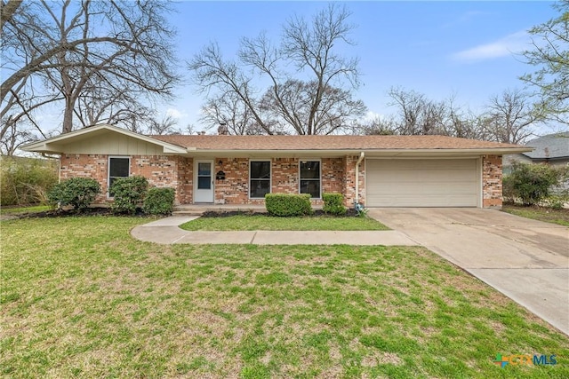 single story home with a front yard, a chimney, concrete driveway, a garage, and brick siding