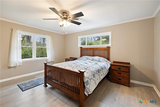 bedroom with baseboards, wood finished floors, a ceiling fan, and ornamental molding