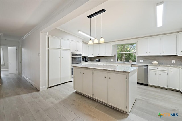 kitchen featuring a center island, backsplash, stainless steel appliances, and ornamental molding