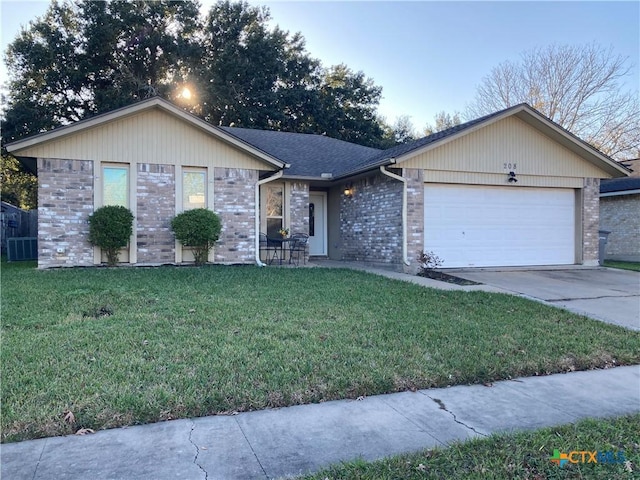 ranch-style home with a garage and a front lawn