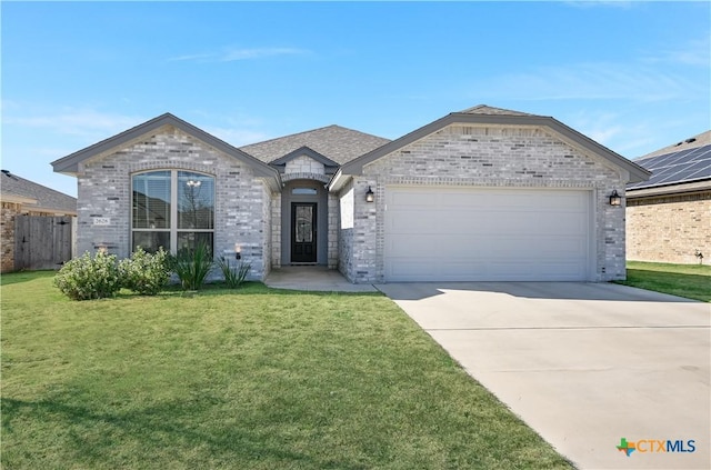 view of front of house featuring a garage and a front yard