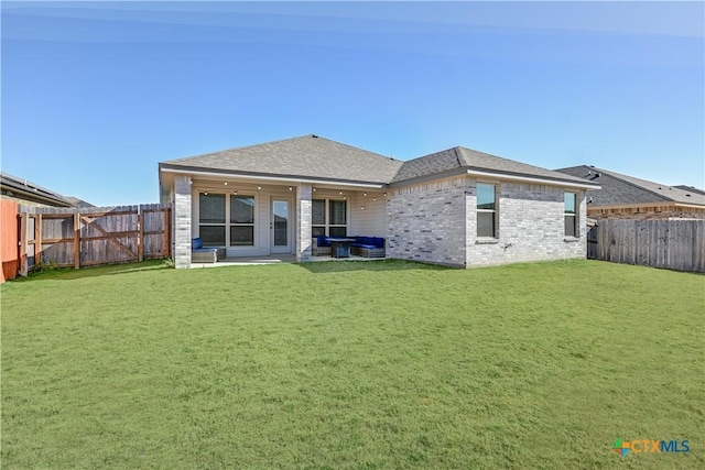 rear view of house with a yard and a patio