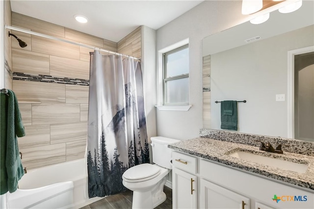 full bathroom with shower / bath combination with curtain, vanity, and toilet