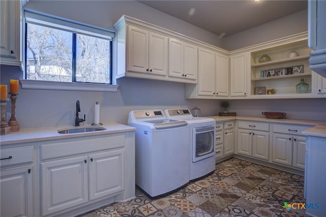 laundry area featuring a sink, cabinet space, and washer and dryer