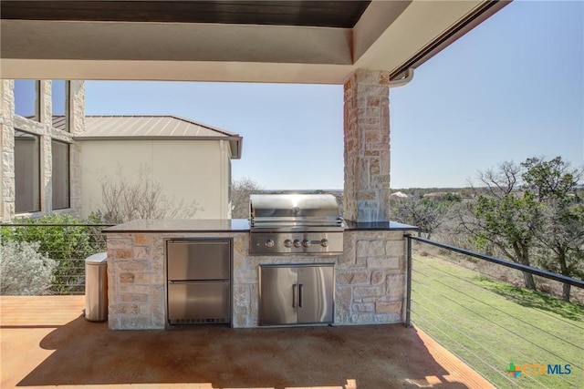 view of patio featuring exterior kitchen and area for grilling