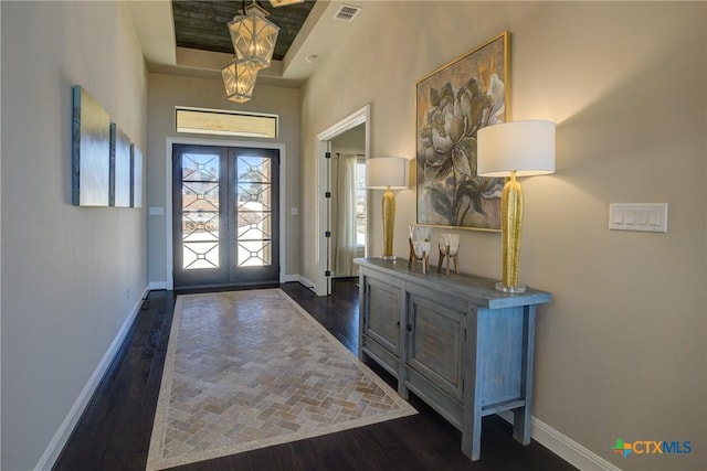 foyer with baseboards, visible vents, dark wood-style flooring, and french doors