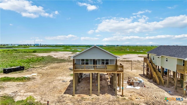 rear view of property featuring a wooden deck and a rural view